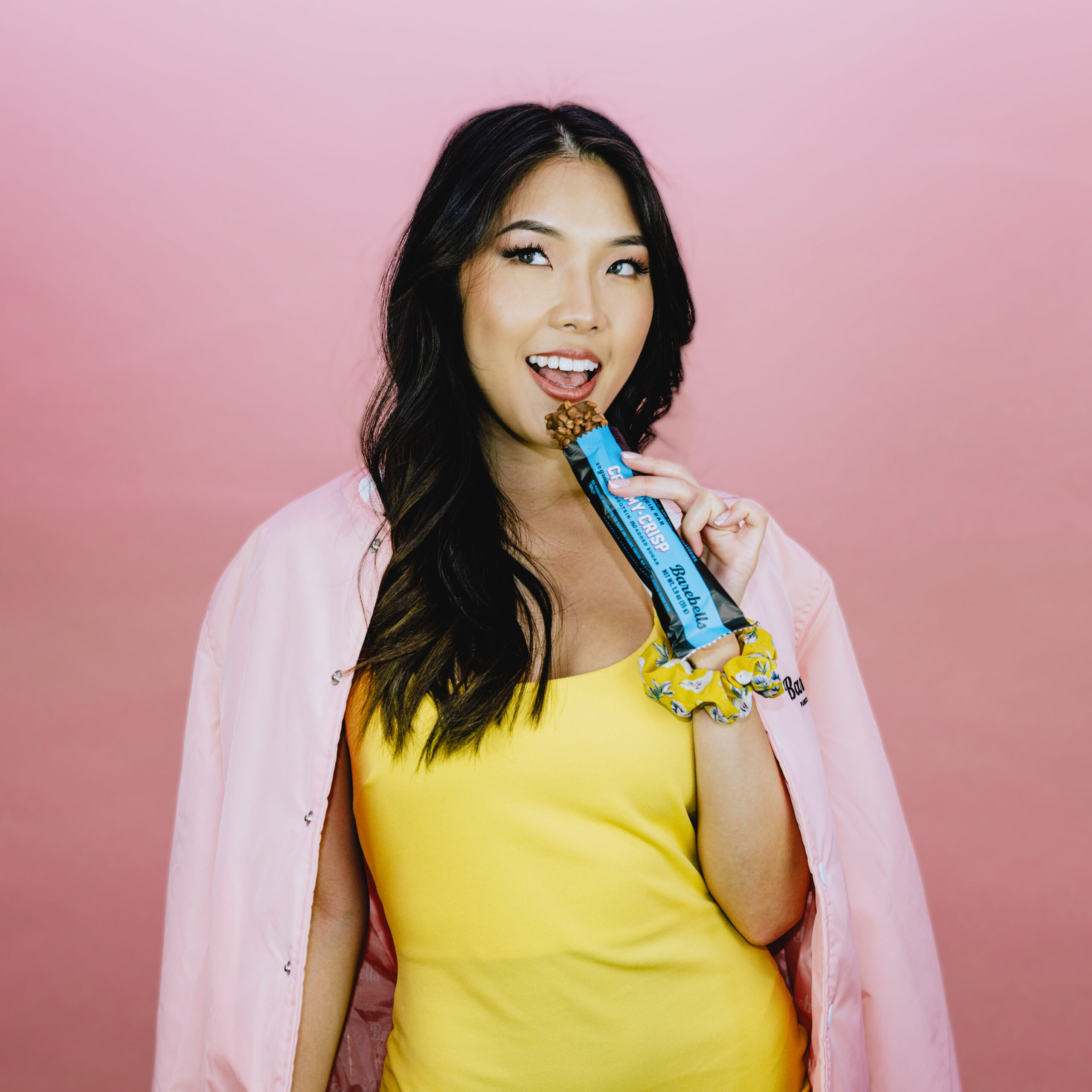 barebells creamy crisp protein bar in hand model lifestyle image